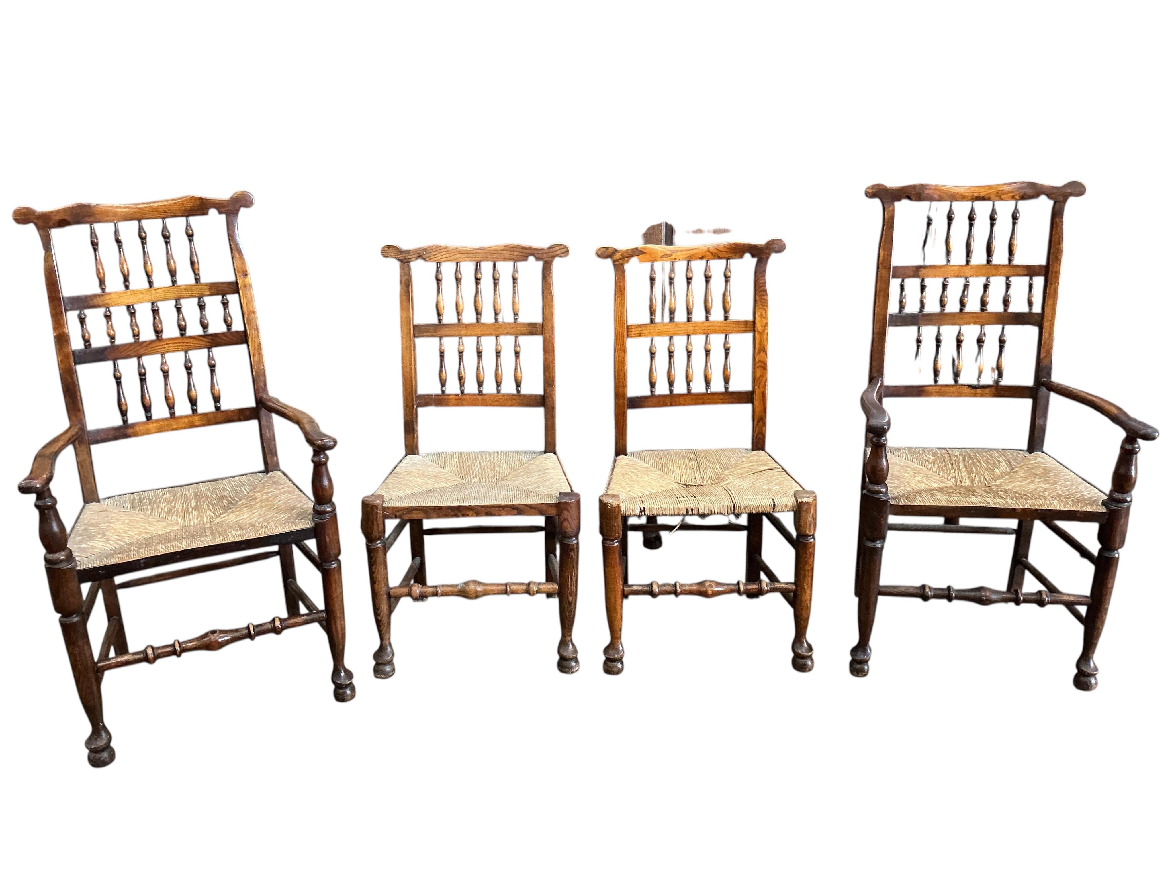 A harlequin set of eight (six plus two) Derbyshire style elm and beech rush seat spindle back dining chairs, two with arms